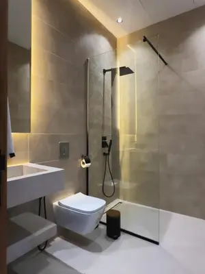 a bathroom with a shower and a toilet and a sink at Modern Villa Assia in Marrakech