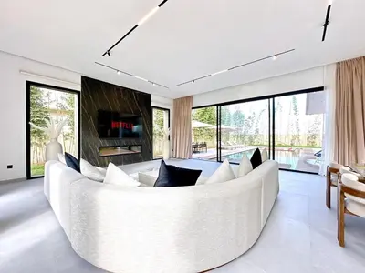 a white living room with a large white couch at Modern Villa Assia in Marrakech