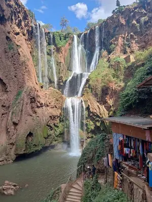 a waterfall on the side of a mountain at Riad zineb au cœur de Marrakech &3 Piscines &Jacuzzi & Petit-Déjeuner& parking gratuit in Marrakech