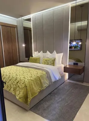 a bedroom with a large bed and a mirror at Prestige Cocon in Marrakech