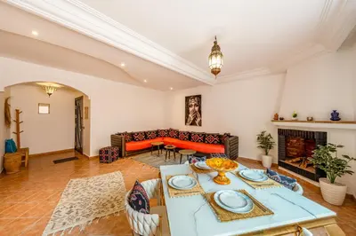 a living room with a couch and a table at Perle Au cœur de Gueliz avec Piscine et 100m2 in Marrakech