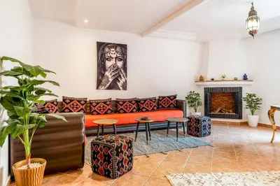 a living room with a couch and a fireplace at Perle Au cœur de Gueliz avec Piscine et 100m2 in Marrakech