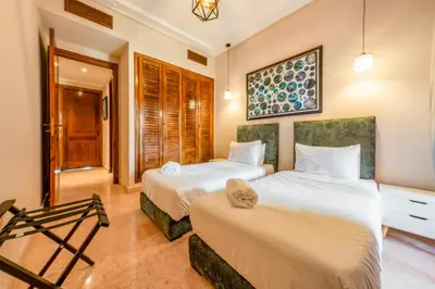 two beds in a hotel room with at Cozy Stay with Garden & Pool, 10min to Center in Marrakech