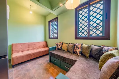 a living room with a couch and a window at Cozy Stay with Garden & Pool, 10min to Center in Marrakech