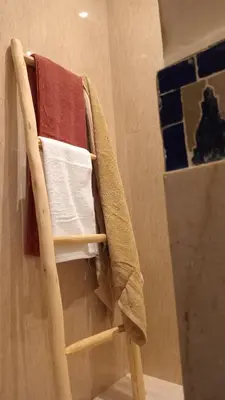 a wooden towel rack in a bathroom at Coeur de Marrakech Majorelle 2ch Parking in Marrakech