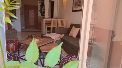a living room with a couch and a table at Coeur de Marrakech Majorelle 2ch Parking in Marrakech