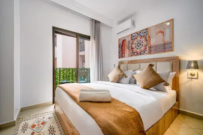 a bedroom with a large bed and a window at Appartement Luxe à Marrakech in Marrakech