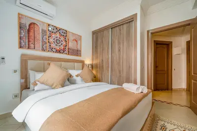 a bedroom with a large white bed in a room at Appartement Luxe à Marrakech in Marrakech