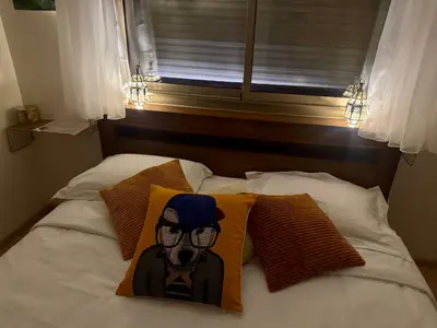 a bed with a pillow with a picture of a dog at Marrakech 3 ch piscine et déco artisanale parfait business et famille in Marrakech