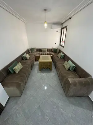 a living room with a large couch and a table at Modern Apartment in Great Location of Marrakesh in Marrakech