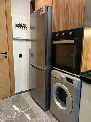 a kitchen with a refrigerator and a washing machine at cozy apartment in Marrakesh in Marrakech