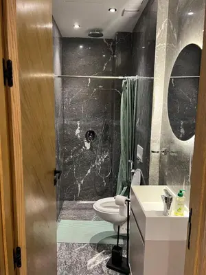 a bathroom with a shower with a toilet and a sink at cozy apartment in Marrakesh in Marrakech