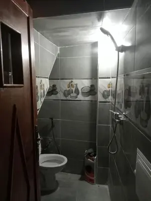 a small bathroom with a toilet and a shower at Passenger house in Marrakech