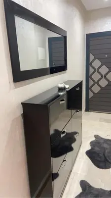 a black desk with a television on a wall at Homesweethome in Marrakech