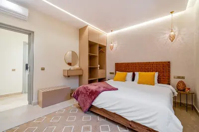 a bedroom with a large bed with yellow pillows at Lux & comfort Sunny terrace in Gueliz in Marrakech