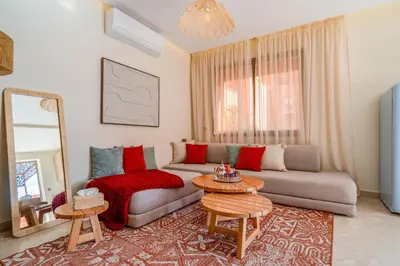 a living room with a couch and a table at Lux & comfort Sunny terrace in Gueliz in Marrakech