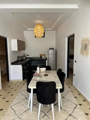 a kitchen and dining room with a table and chairs at Villa Familiale avec Piscine Privée à Marrakech in Marrakech