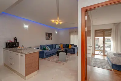 a living room with a blue couch and a table at pearl garden in Marrakech