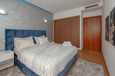 a bedroom with a large bed with a blue headboard at pearl garden in Marrakech