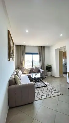 a living room with a couch and a table at Bewelcome in Marrakech