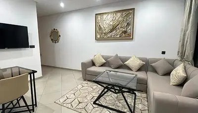 a living room with a couch and a tv at Bewelcome in Marrakech