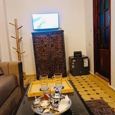 a living room with a table with glasses on it at Dar Bellaji l Bed & Breakfast in Medina l Rooftop Koutoubia in Marrakech