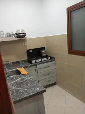 a small kitchen with a stove and a sink at dar immi in Marrakech