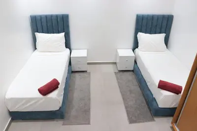 two twin beds in a room at appartement 3 chambres gueliz only families in Marrakech