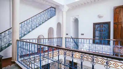 a staircase in a house with blue and white tiles at Riad KAN ZAMAN in Marrakech