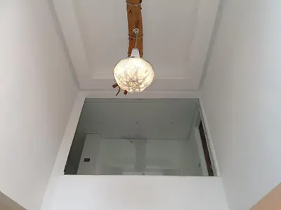 a light hanging from a ceiling with a glass window at Luxurious villa in Marrakech