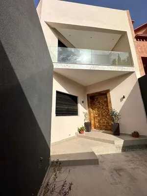 a house with a large window on the side of it at Luxurious villa in Marrakech