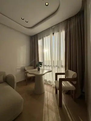 a living room with a couch and a table at Appartement Siniya Cosy à Marrakech in Marrakech