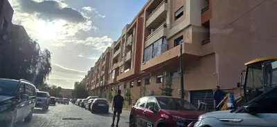 a man walking down a street next to a building at Bonheur partagé 2 in Marrakech