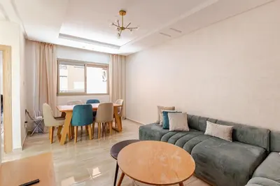 a living room with a couch and a table at Spacieux 3 chambre au Coeur de Marrakech in Marrakech