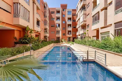 a swimming pool in the middle of a building at Spacieux 3 chambre au Coeur de Marrakech in Marrakech