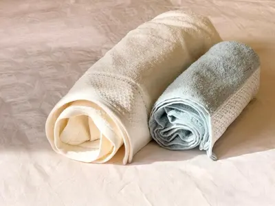two towels sitting on top of a bed at Maison de Vacances Targa avec Piscine & Terrasse à Marrakech in Marrakech