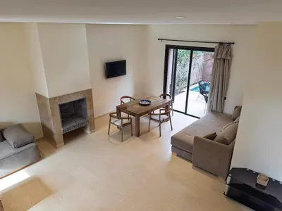 a living room with a couch and a table at Maison de Vacances Targa avec Piscine & Terrasse à Marrakech in Marrakech