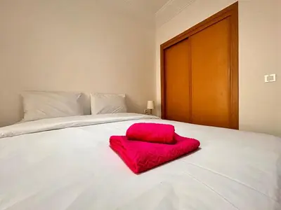 a red pillow sitting on top of a white bed at Lumière in Marrakech