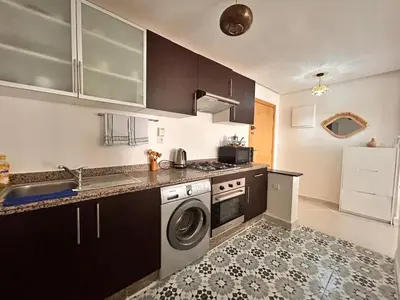 a kitchen with a washing machine and a sink at Lumière in Marrakech