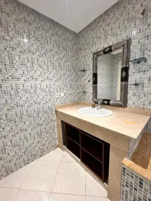 a bathroom with a sink and a mirror at Lumière in Marrakech