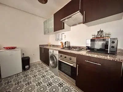 a kitchen with a sink and a stove top oven at Lumière in Marrakech