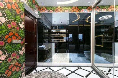 a lobby with a floral wallpaper on the wall at Une Galerie Dans Le ciel - Hivernage Marrakech in Marrakech