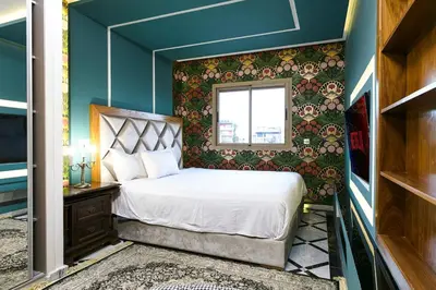 a small bedroom with a bed and a window at Une Galerie Dans Le ciel - Hivernage Marrakech in Marrakech