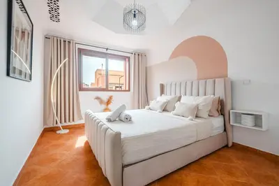 a bedroom with a large white bed with a window at Cozy Studio Well Located Near Gueliz in Marrakech