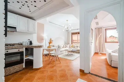 a kitchen and living room with a table and chairs at Cozy Studio Well Located Near Gueliz in Marrakech