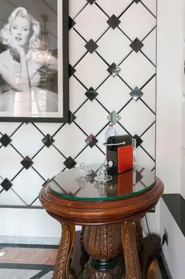 a glass table with a radio on top of it at Maison Elysium Hivernage Marrakech in Marrakech