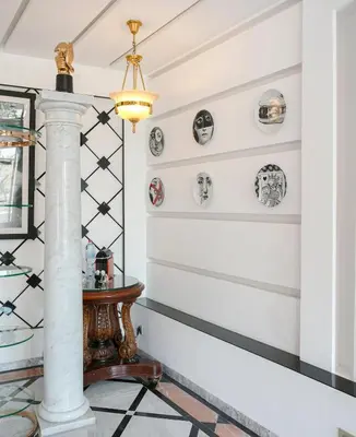 a hallway with black and white plates on the wall at Maison Elysium Hivernage Marrakech in Marrakech