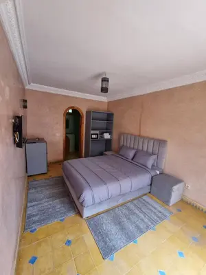 a bedroom with a large bed in a room at Dar Fatna Marrakech in Marrakech