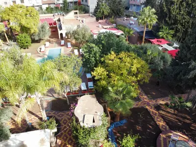 an aerial view of a resort with a pool and trees at Dar Fatna Marrakech in Marrakech