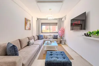 a living room with a couch and a table at Appartement élégant et cosy in Marrakech
